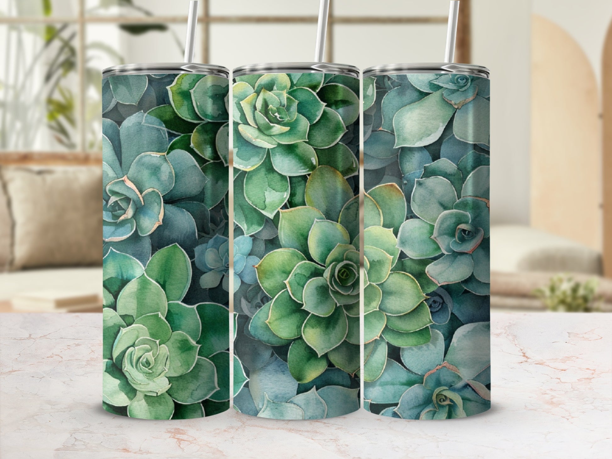 Three tumblers with a succulent plant pattern on a marble surface.