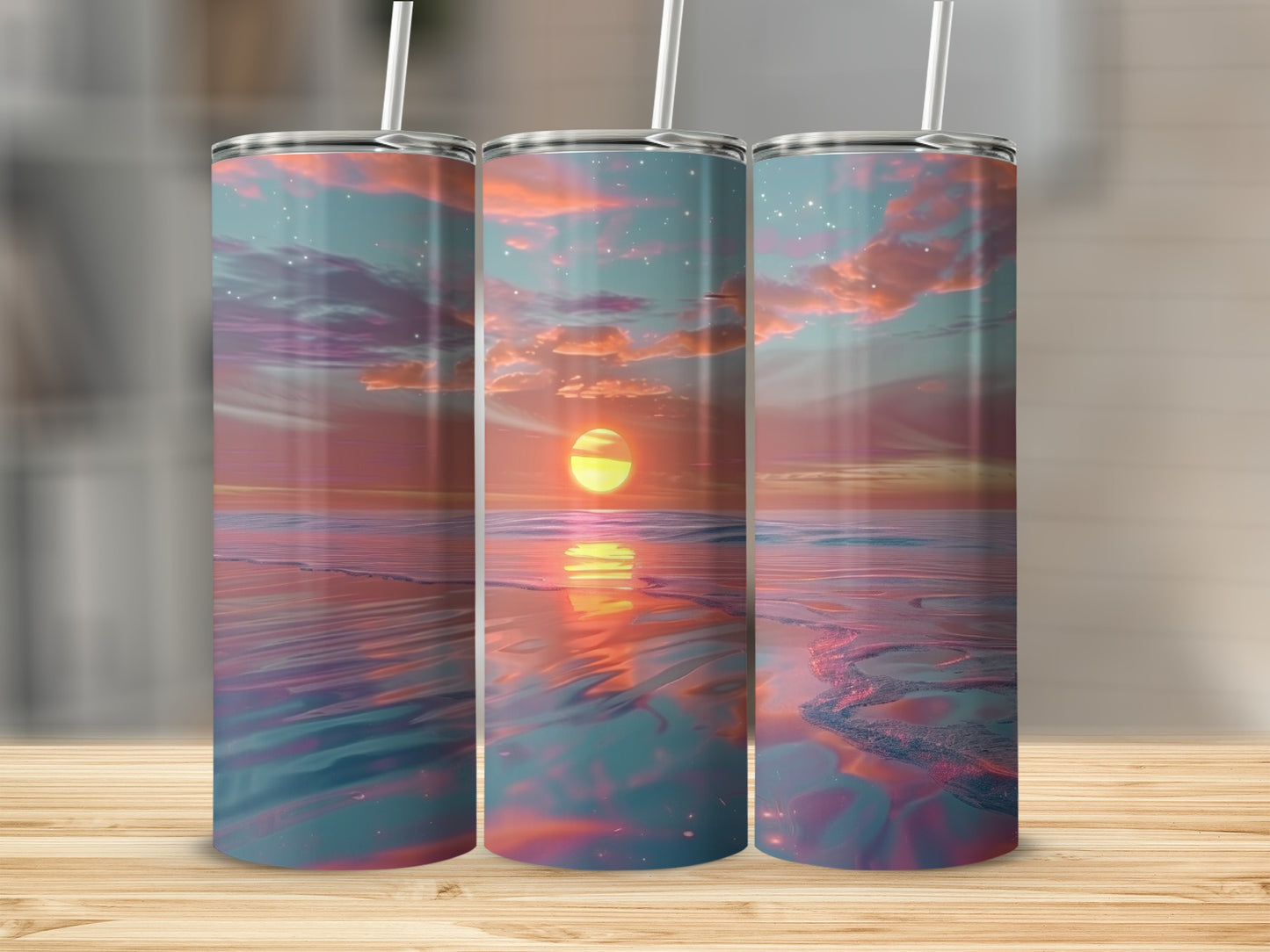 Three tumblers with a sunset over water design, reflecting the sky.