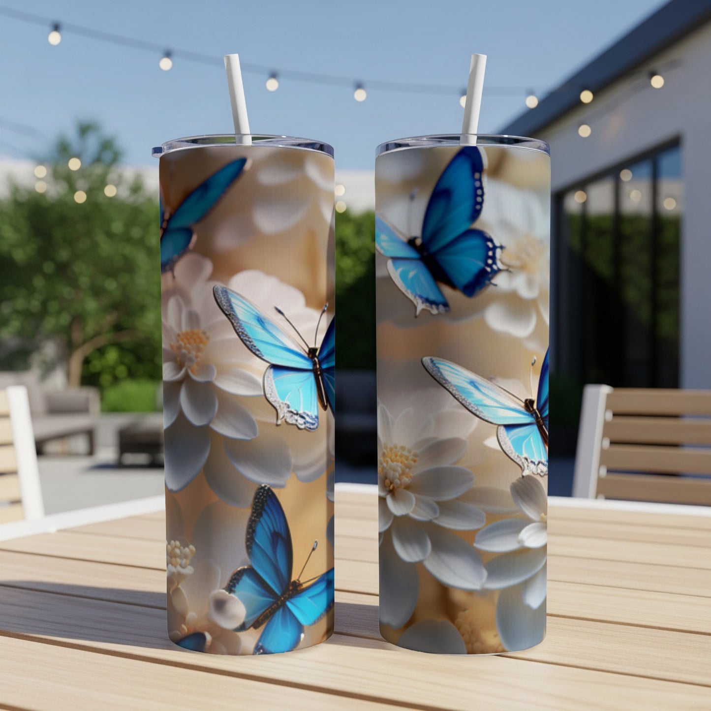 Two tumblers with blue butterflies and white flowers on a light beige background.