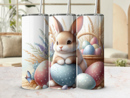 Easter bunny sitting on a blue egg with pastel eggs and a basket.