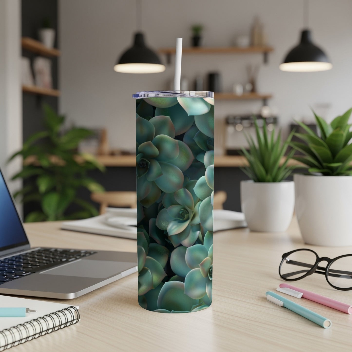 Green succulents pattern on a white tumbler with a straw.