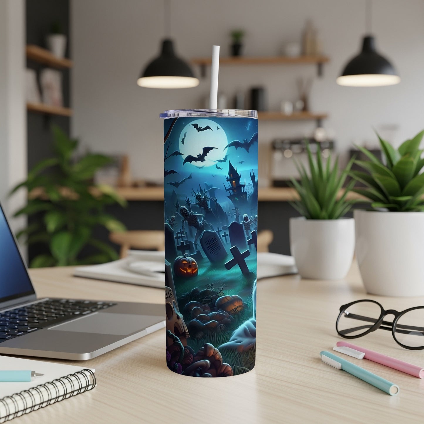 Tumbler with spooky graveyard scene, bats, skeleton, pumpkins, and moon.