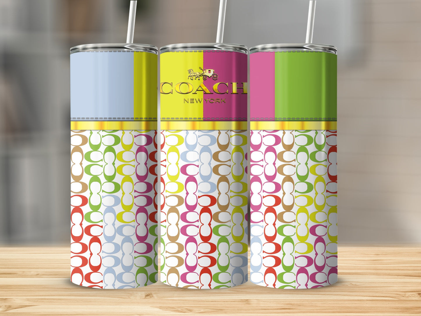 Three Coach New York tumblers with colorful logo patterns and striped tops.