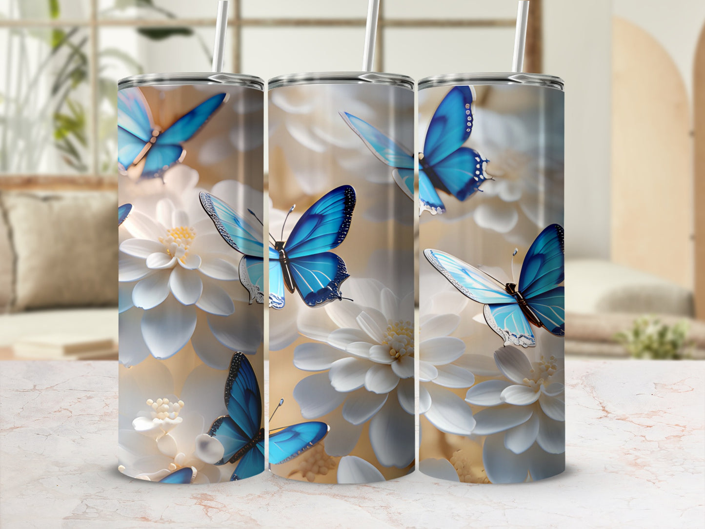 Three tumblers featuring blue butterflies and white flowers on a light background.