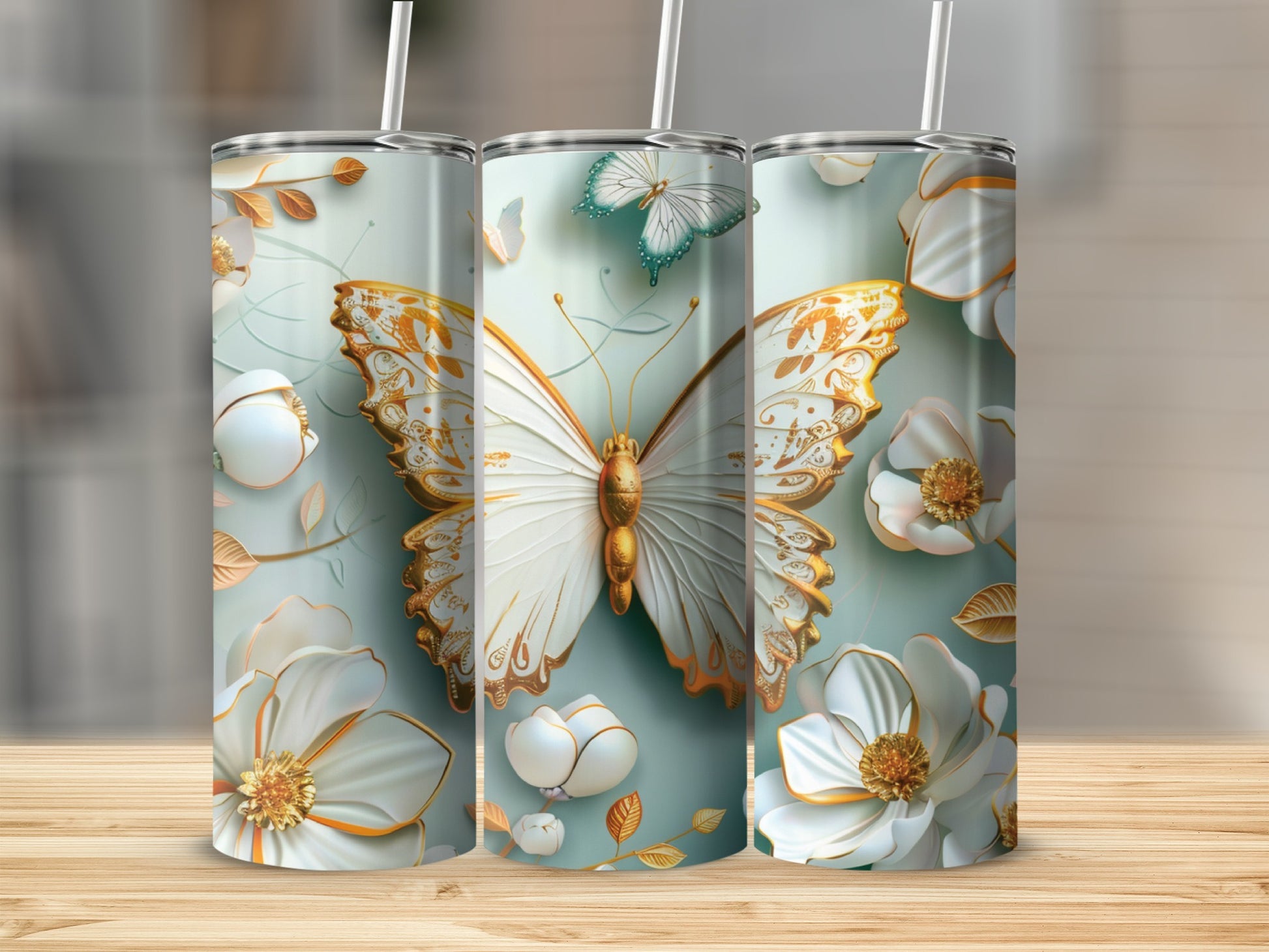 White and gold butterfly with floral accents on a pale blue tumbler.