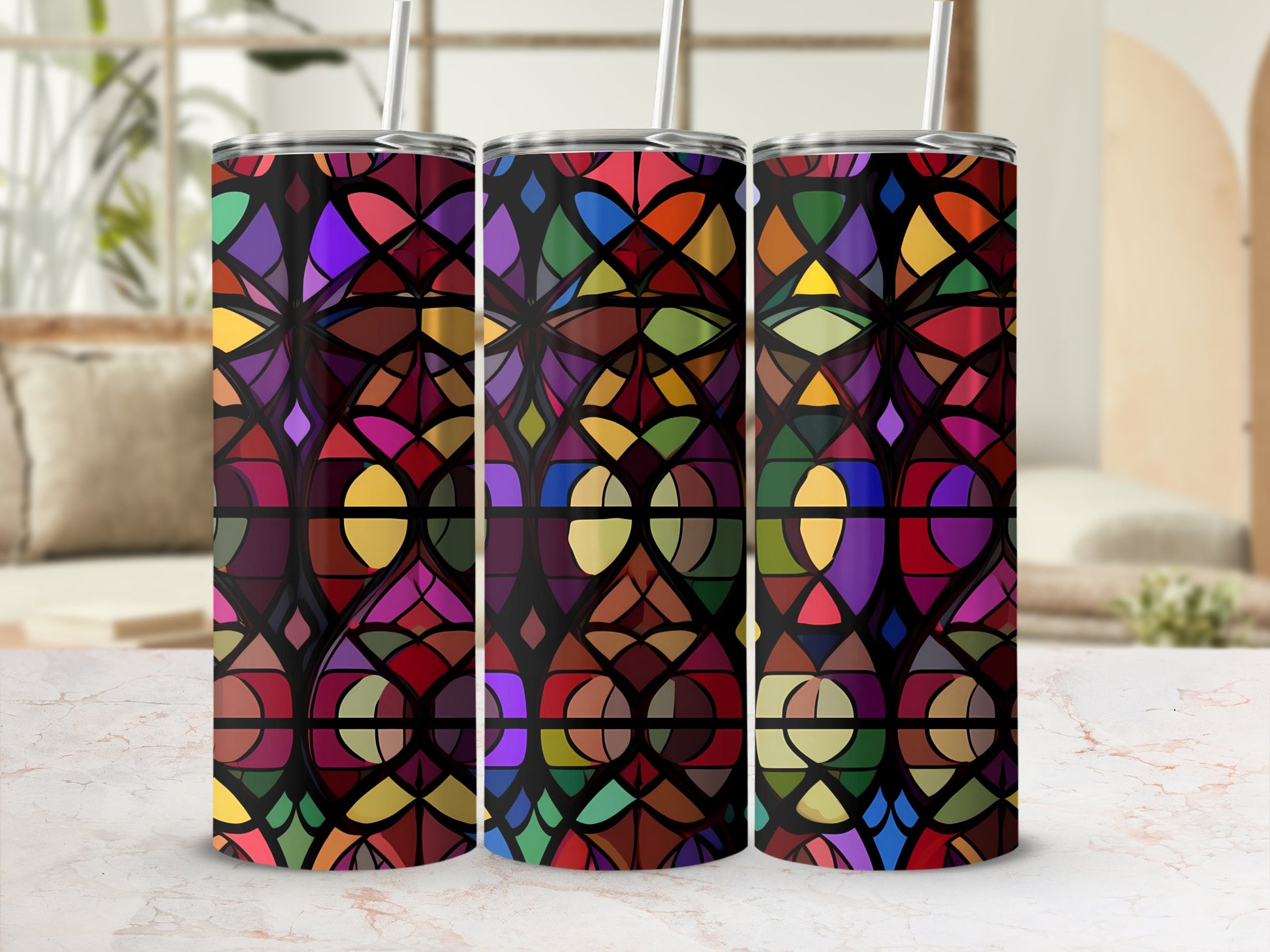 Three tumblers with a stained glass pattern sit on a marble surface.