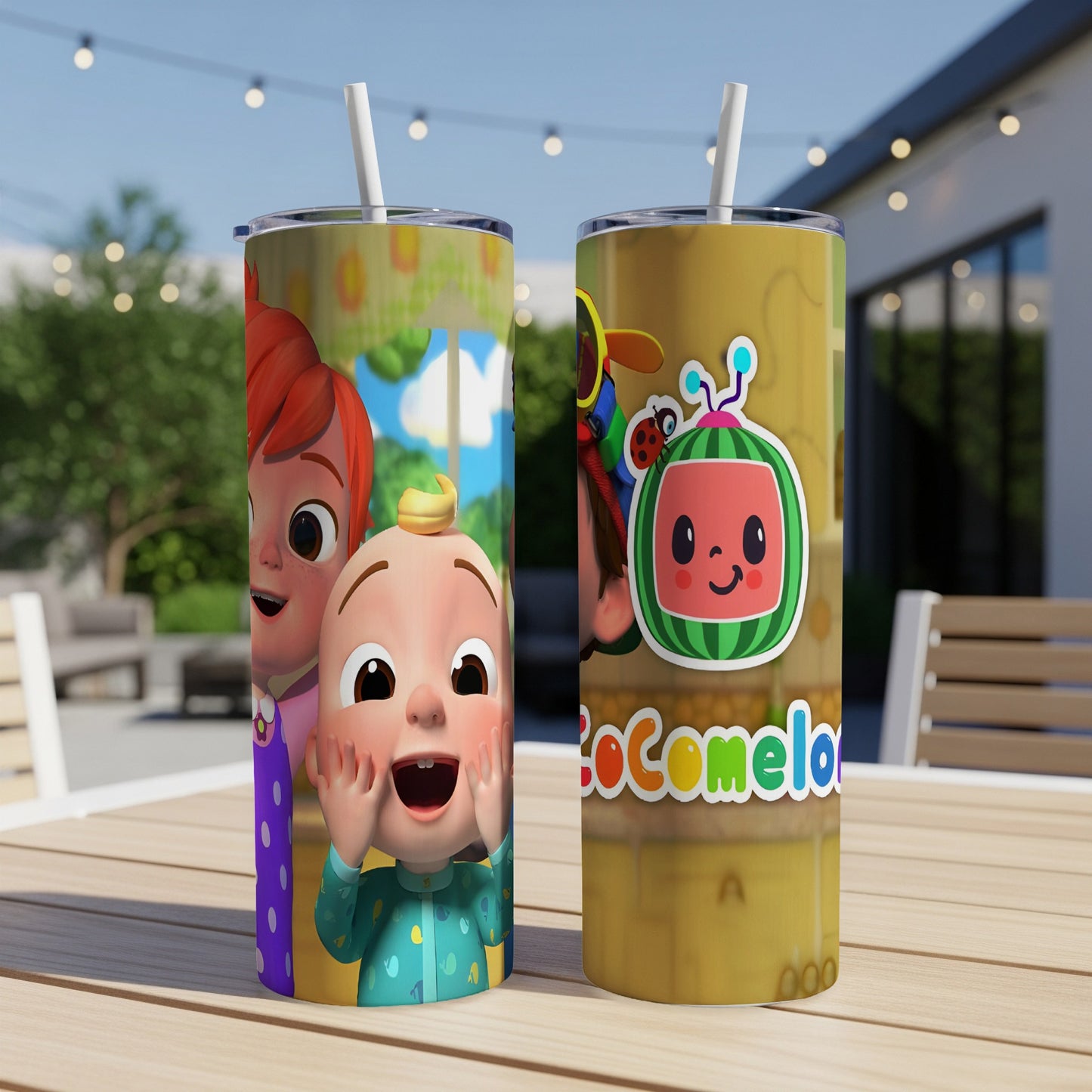 Two Cocomelon tumblers with colorful character designs on a wooden table.