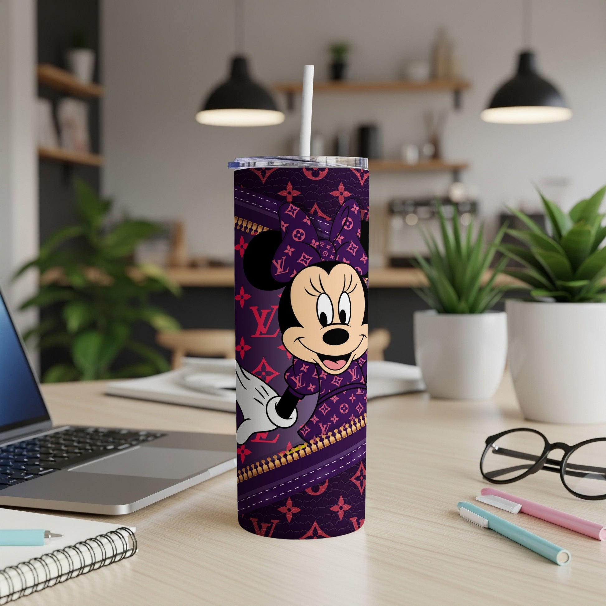Minnie Mouse on a purple tumbler with a zipper pattern.