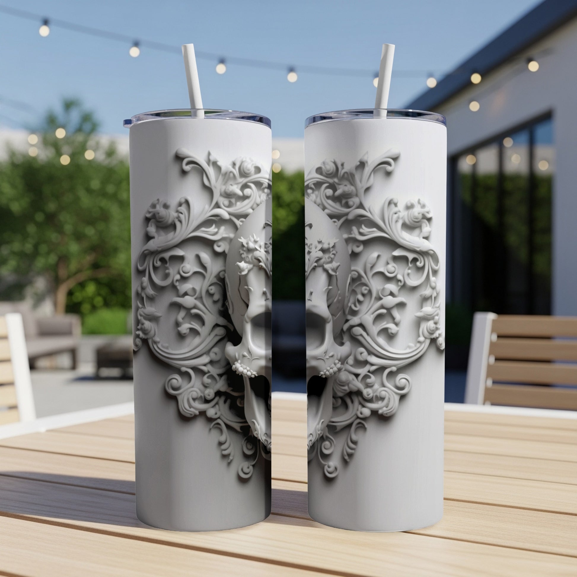 White tumbler with skull and ornate scrollwork design.