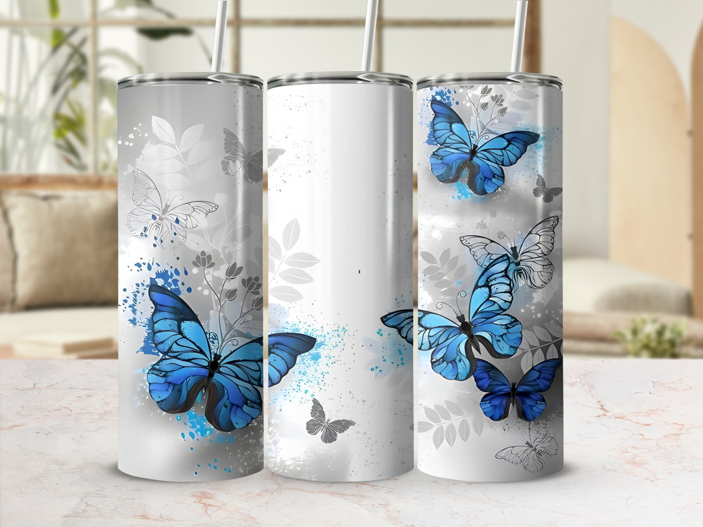 Three tumblers with blue butterflies and floral accents.