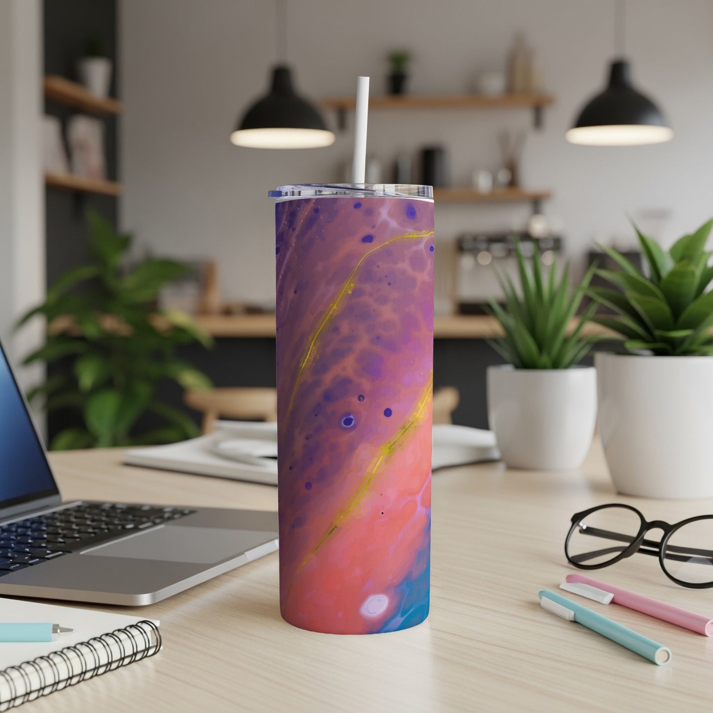 Tumbler with abstract purple, pink, and blue fluid art design and a white straw.