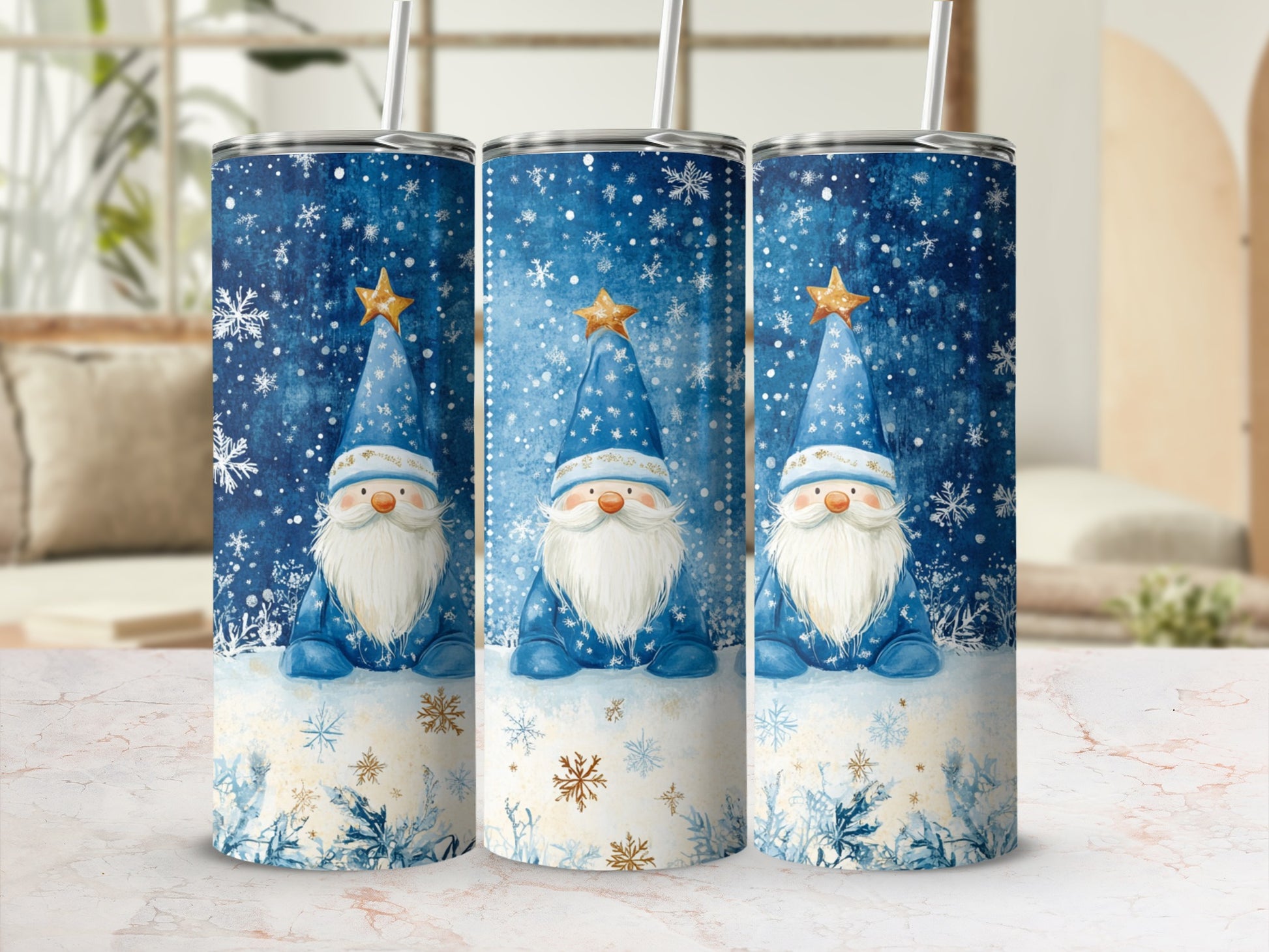 Three tumblers with a blue snowflake gnome design and gold stars.