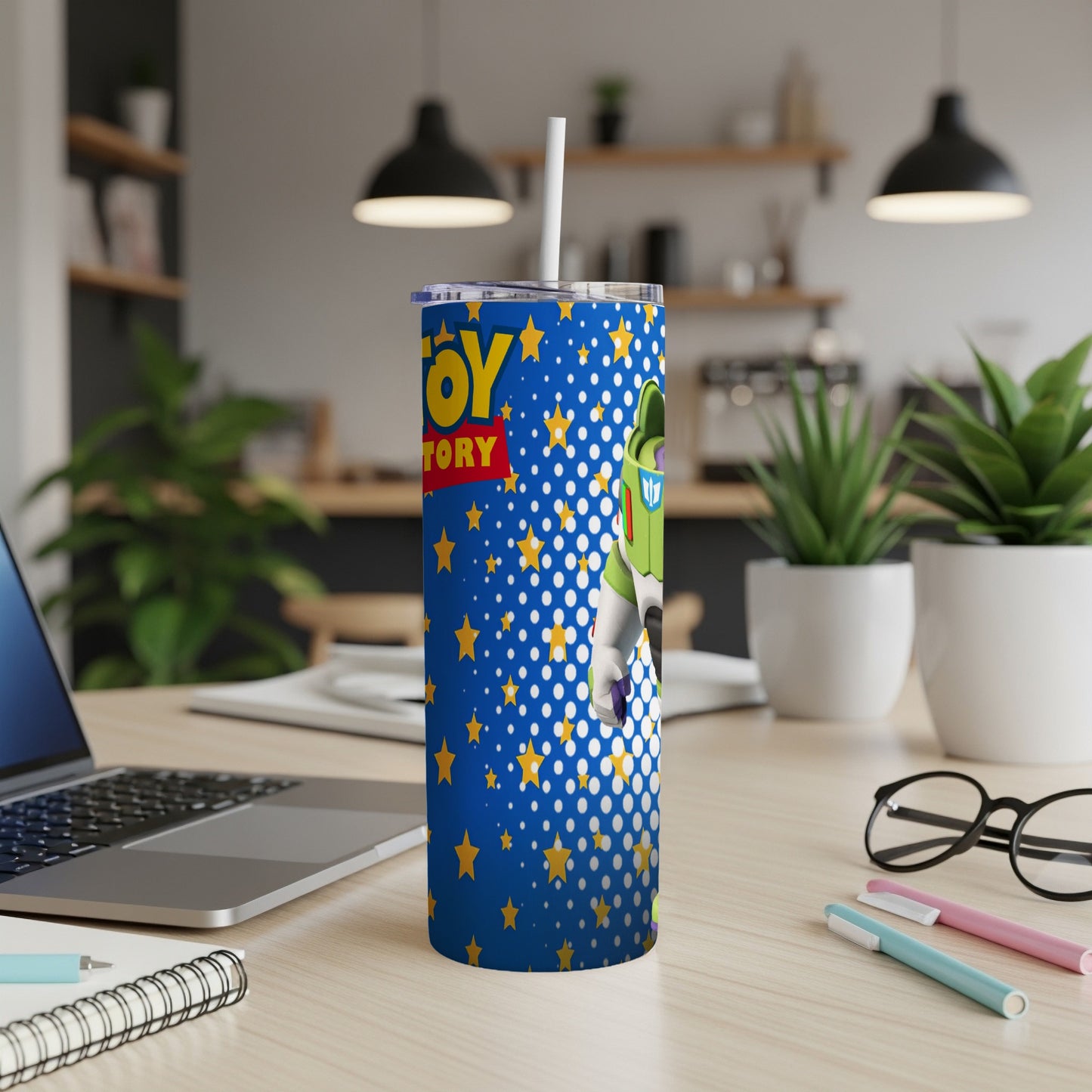 Buzz Lightyear on a blue starry tumbler with straw.