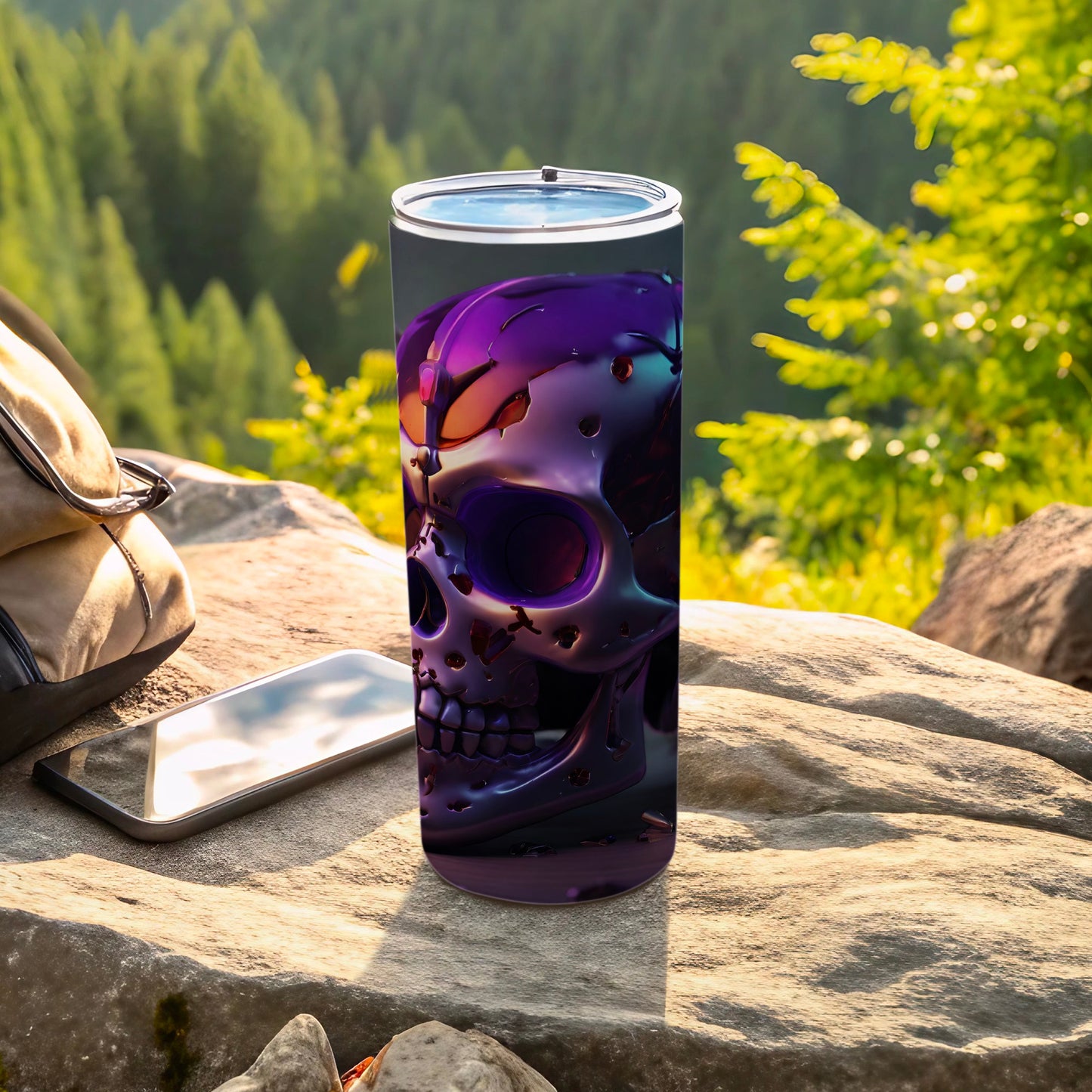Purple metallic skull design on a tumbler cup with phone and backpack.