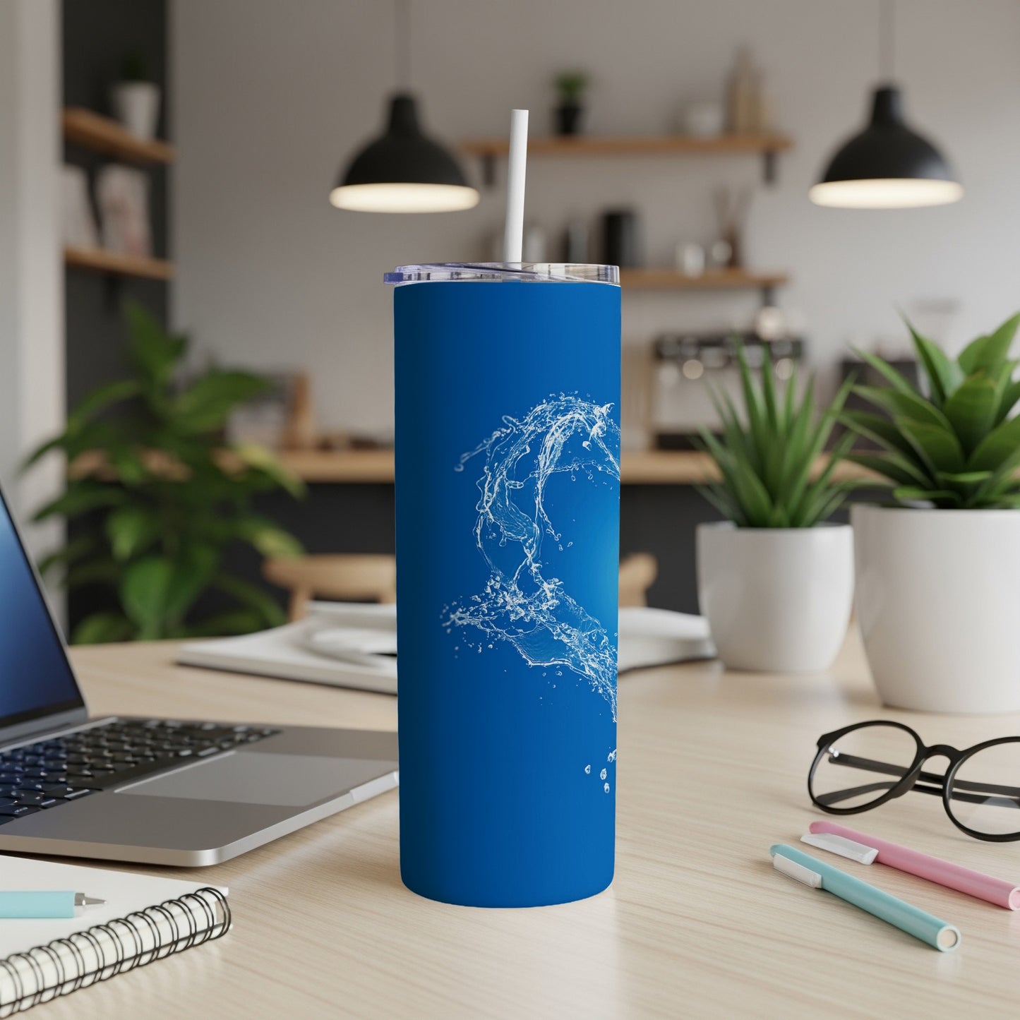 Blue tumbler with white water splash graphic, lid, and straw.