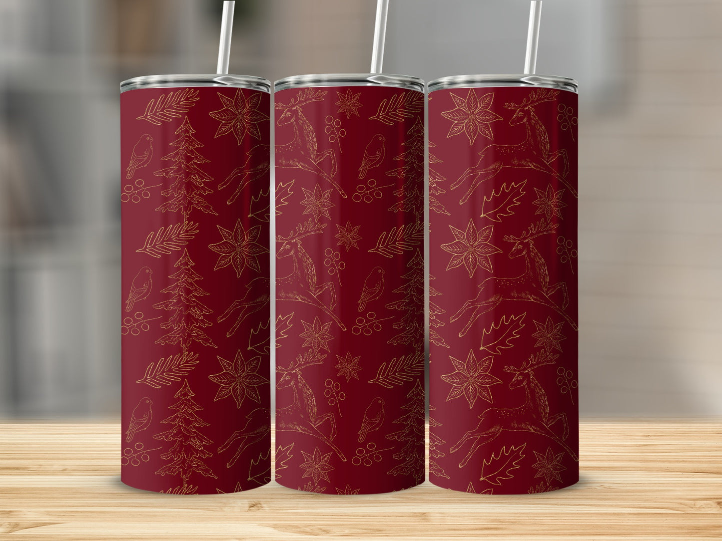 Red tumbler with gold Christmas pattern of deer, trees, and poinsettias.