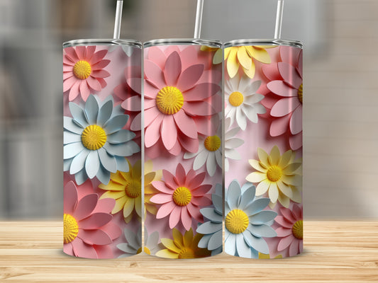 Three tumblers with colorful floral designs in pink, yellow, and blue.