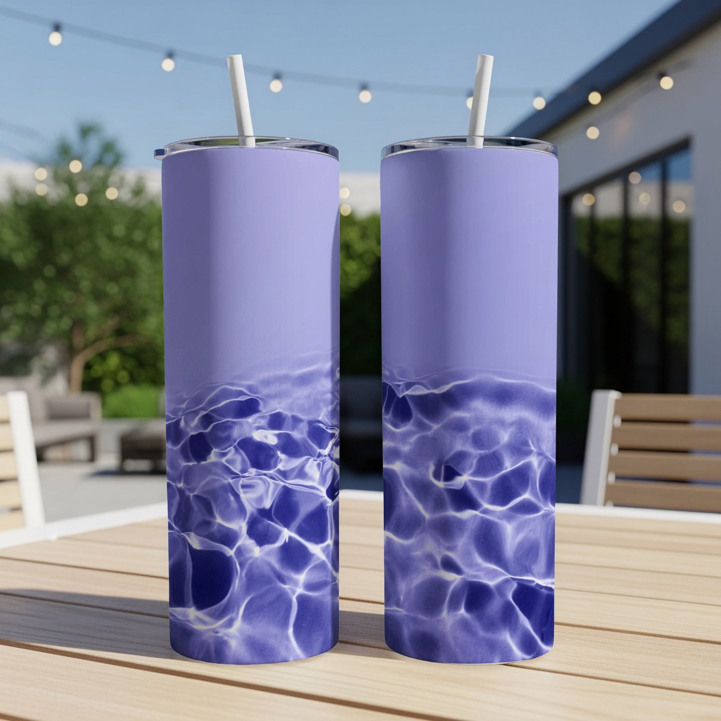 Two tumblers with a water ripple design sit on a table outdoors.