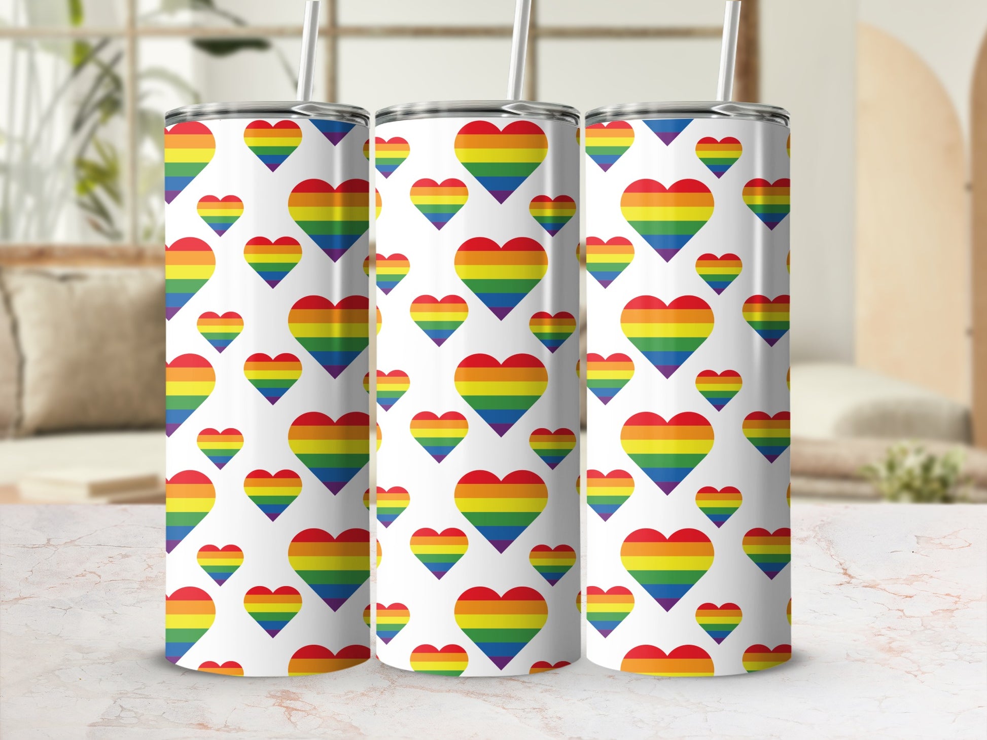 Three tumblers with repeating rainbow heart pattern.