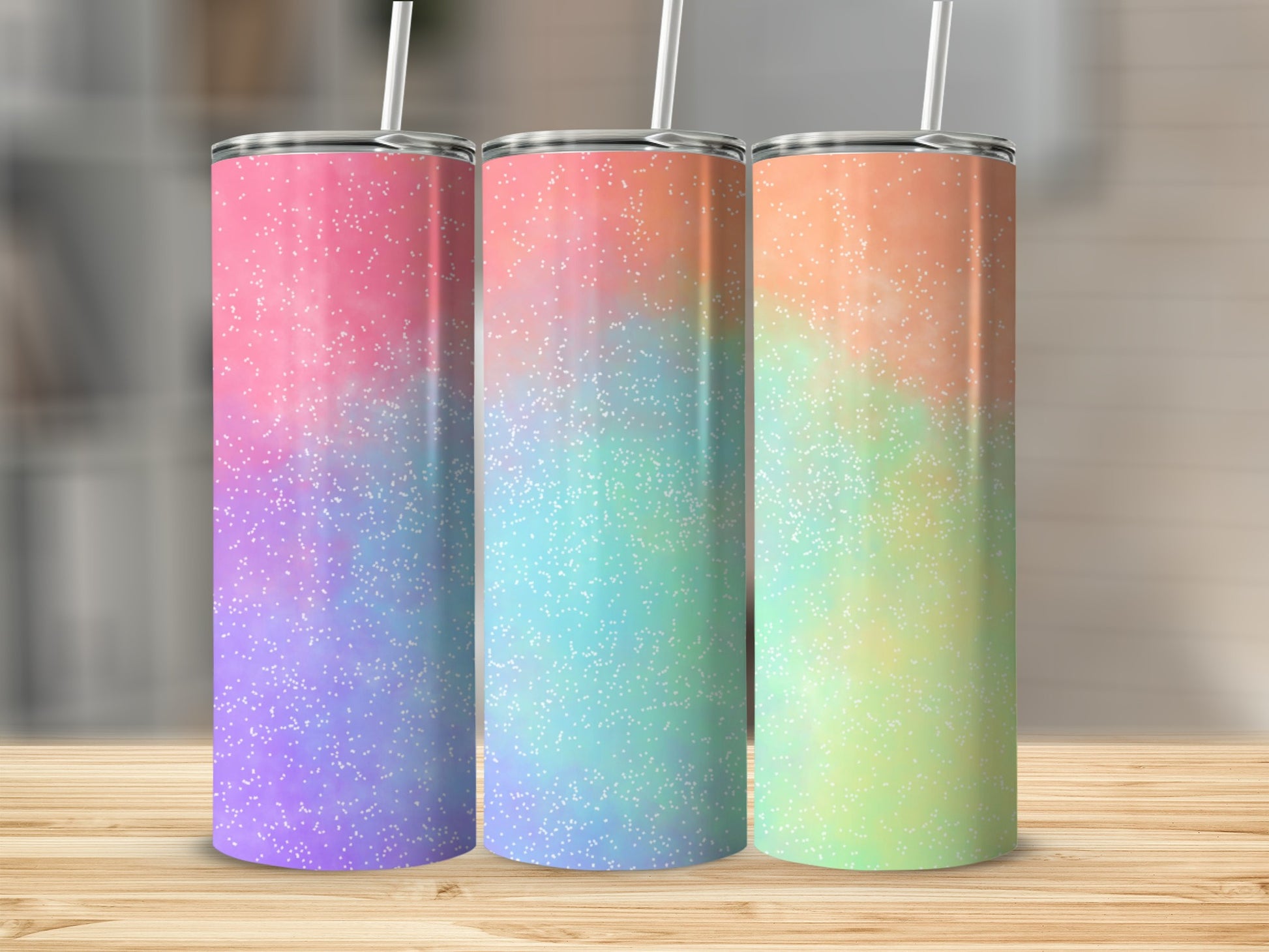 Three tumblers with glittery ombre patterns in pink, teal, and yellow.