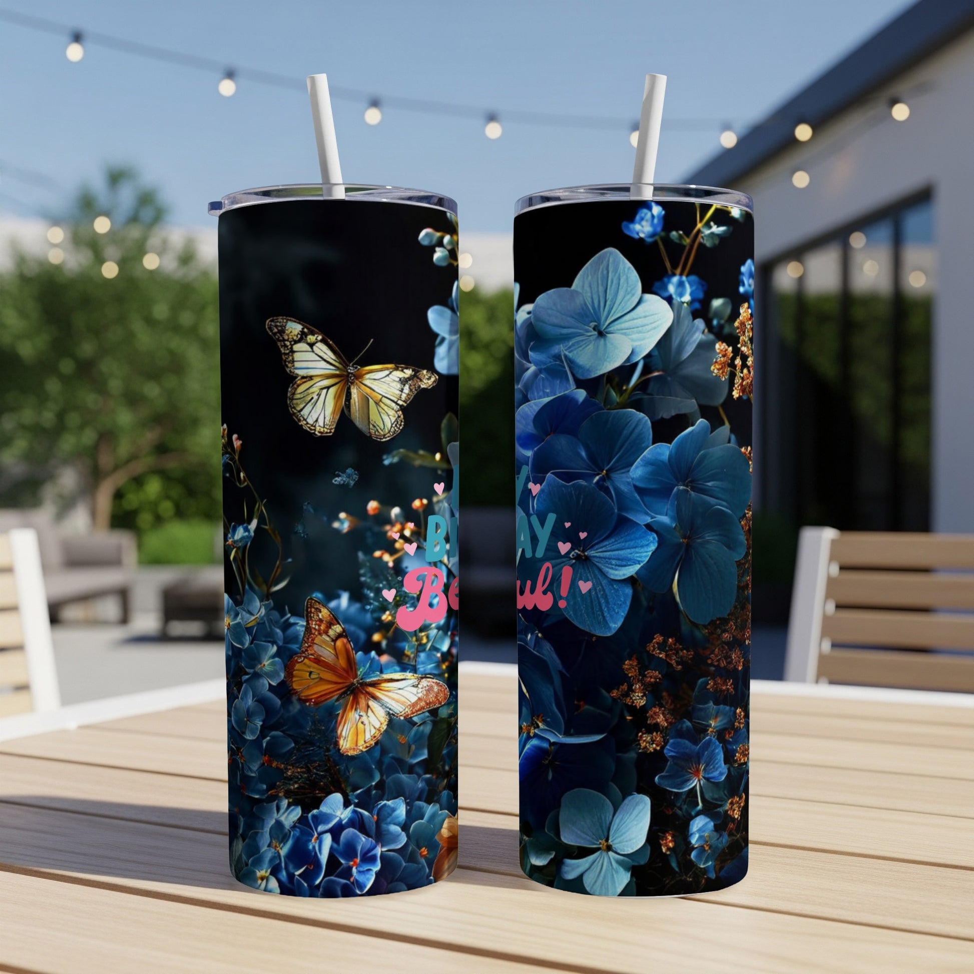 Two tumblers with blue floral and butterfly designs, one with text.