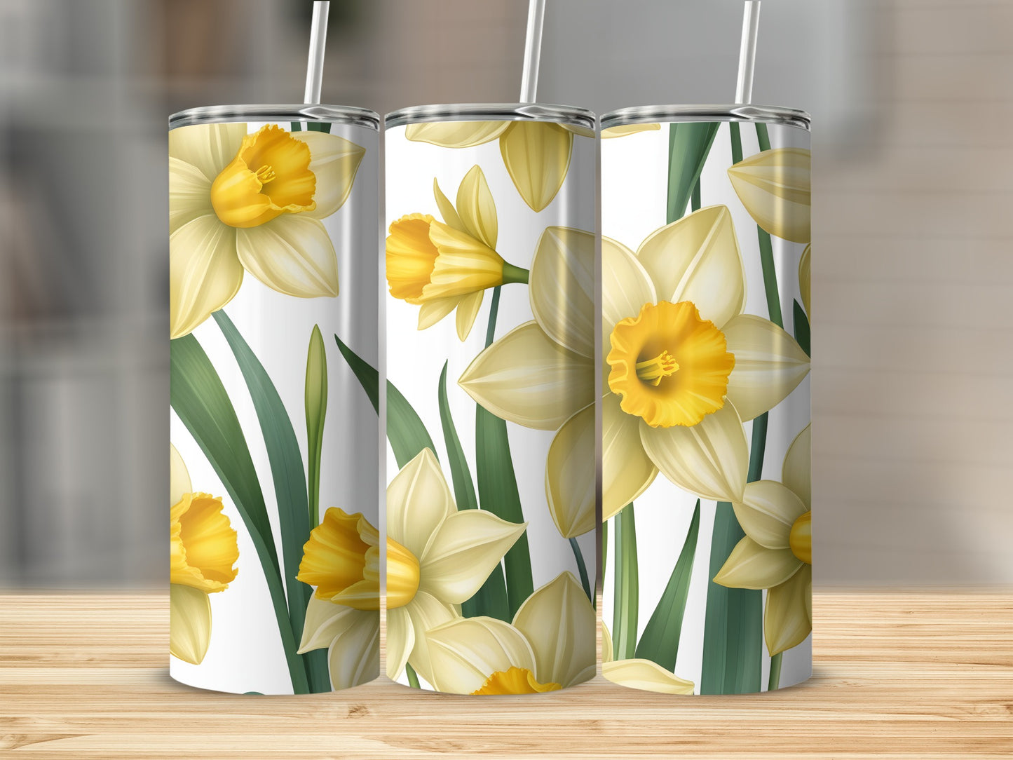 Three tall tumblers with a yellow daffodil floral pattern.