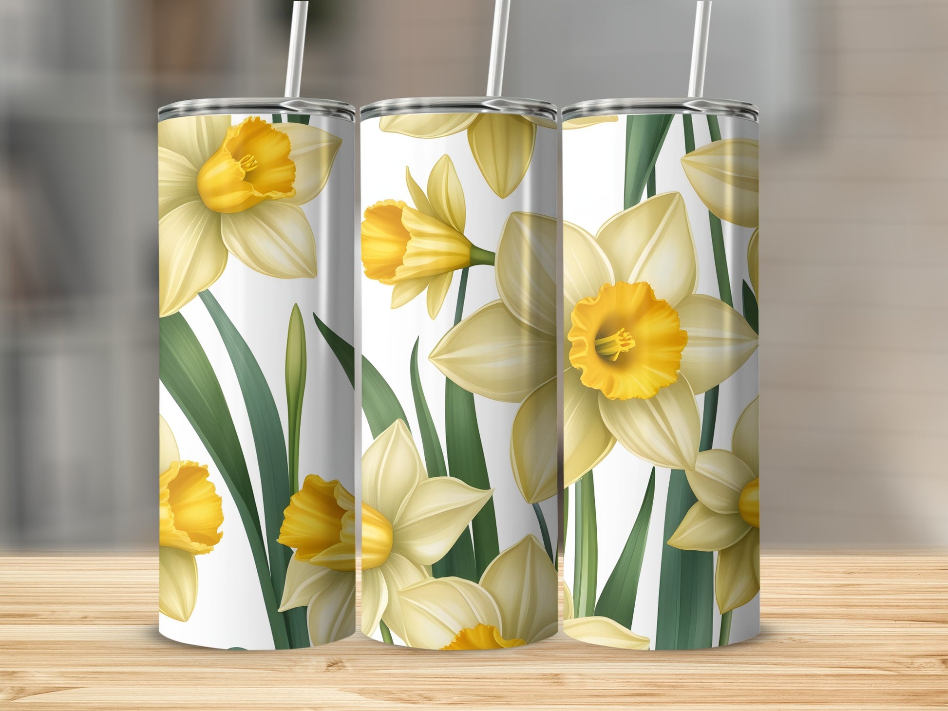 Three tall tumblers with a yellow daffodil floral pattern.