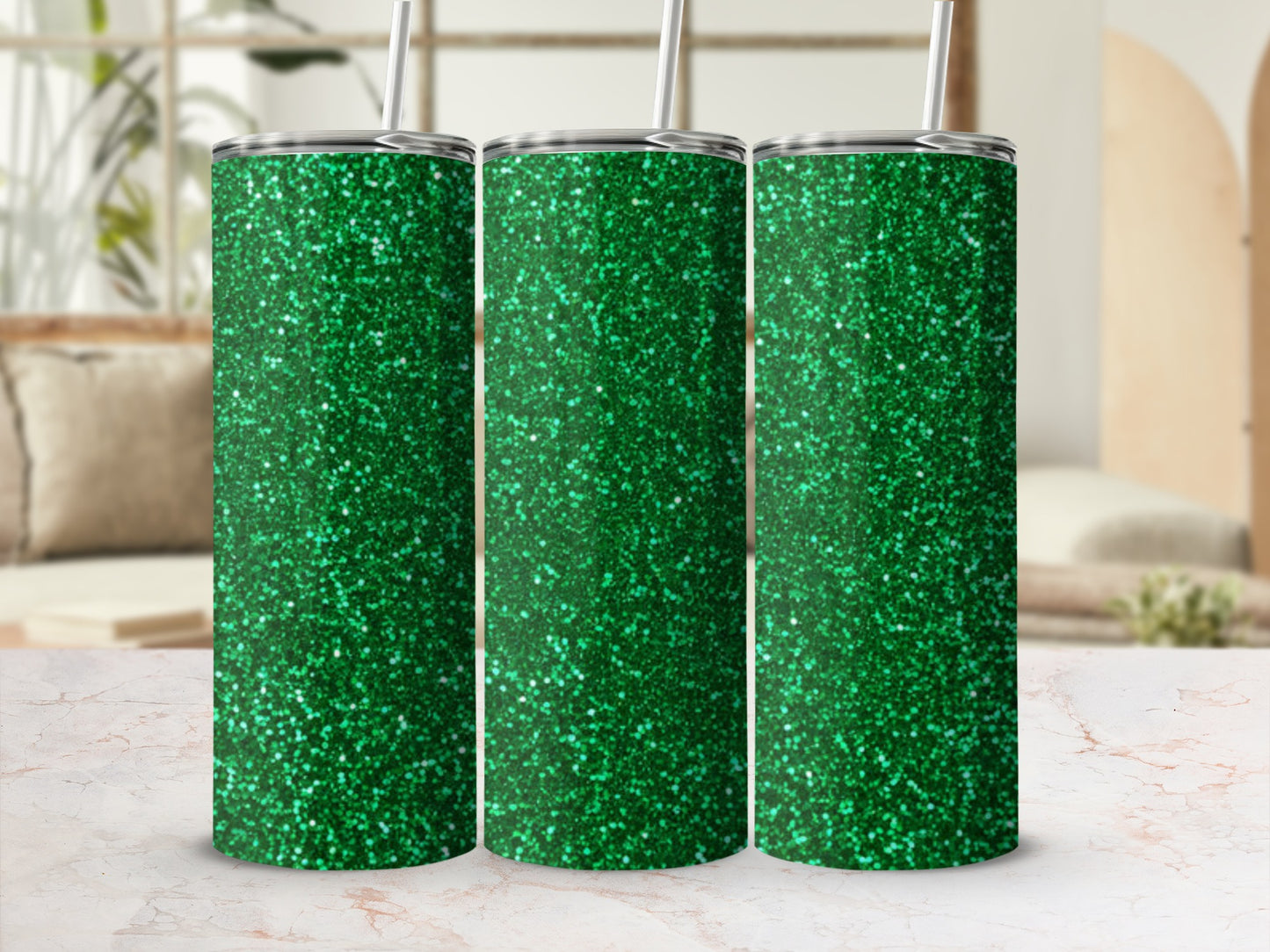 Three green glitter tumblers with straws in a studio setting.
