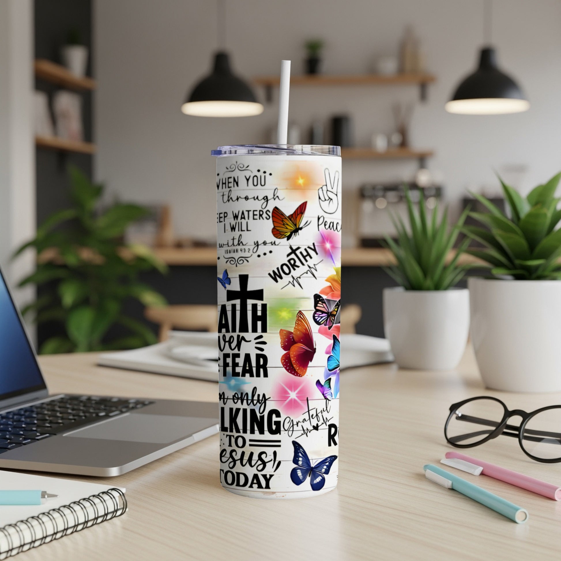 White tumbler with butterfly designs and inspirational text about faith and peace.