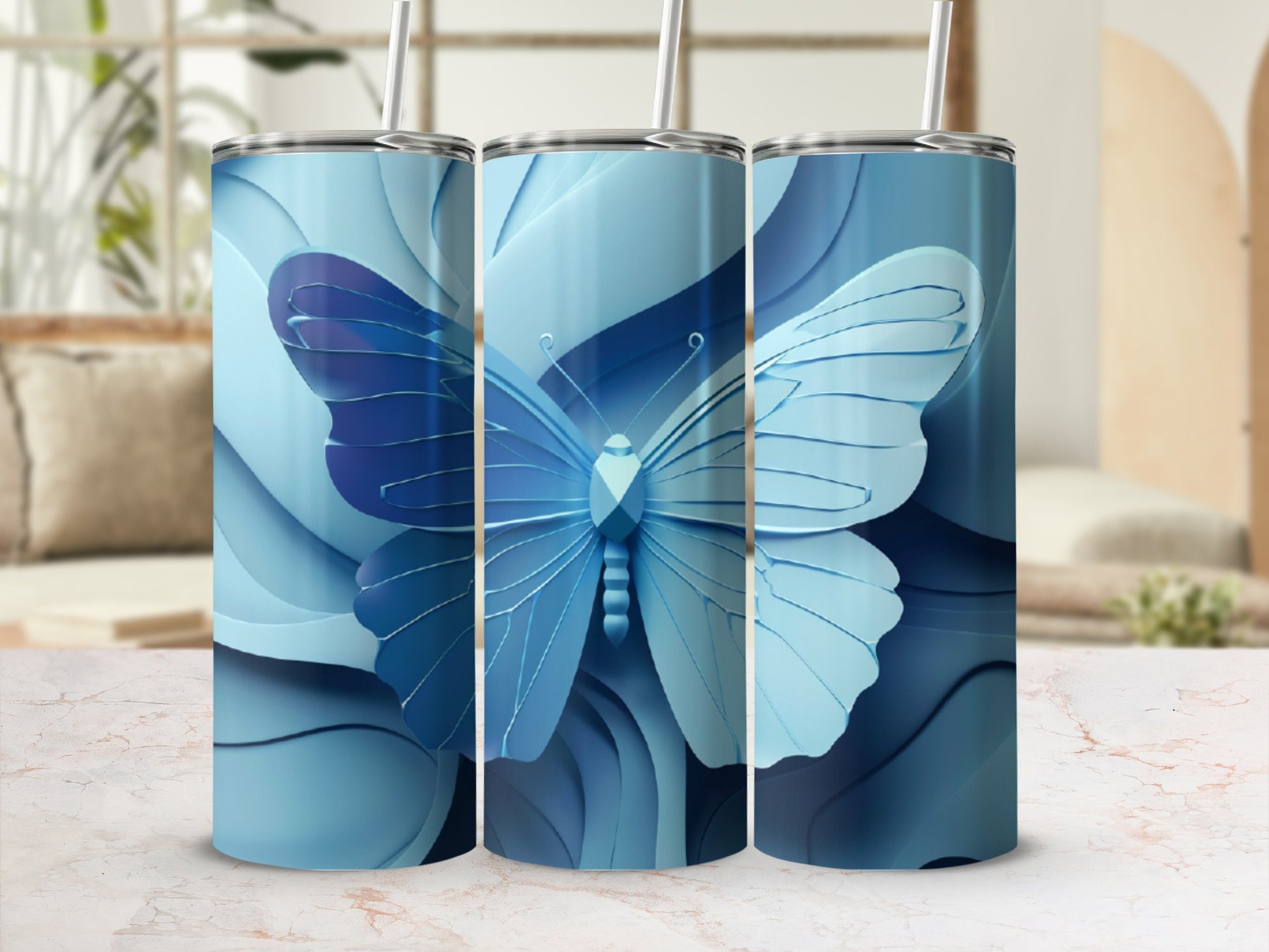 Three blue tumblers with a stylized blue butterfly design.