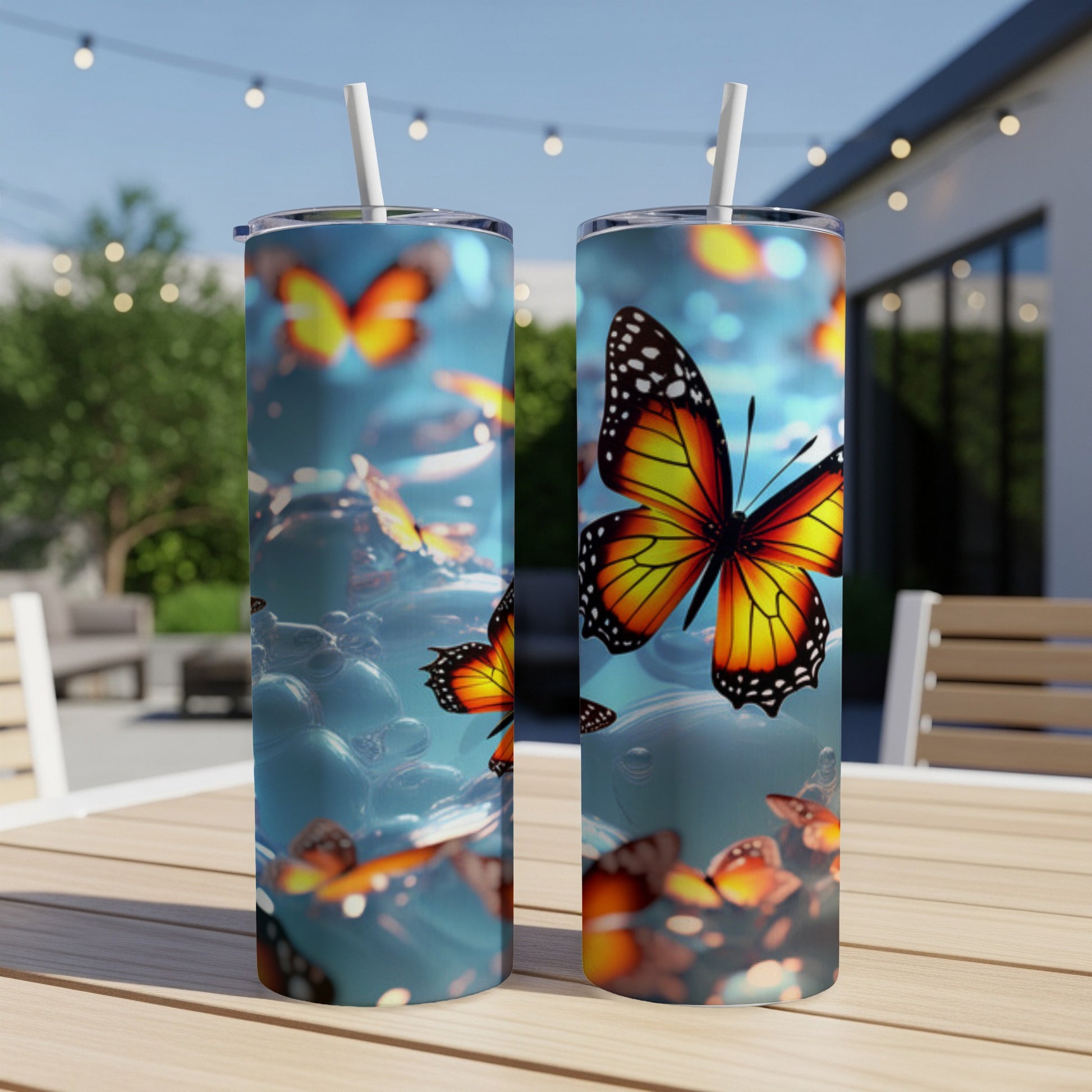 Two tumblers with orange and black butterflies on a bubbly blue background.