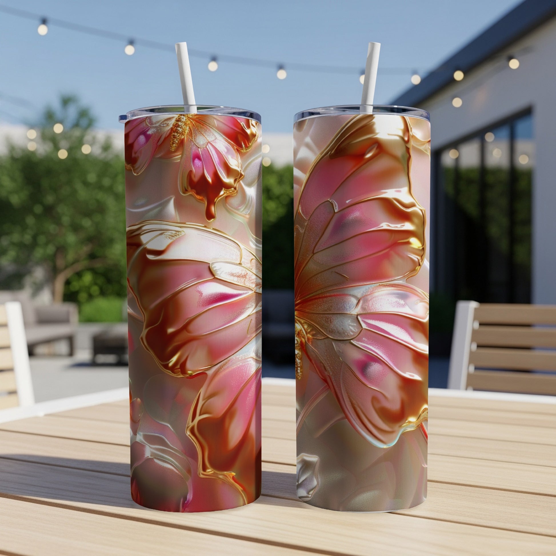 Two tall tumblers with iridescent pink butterfly wing designs on a wooden table.