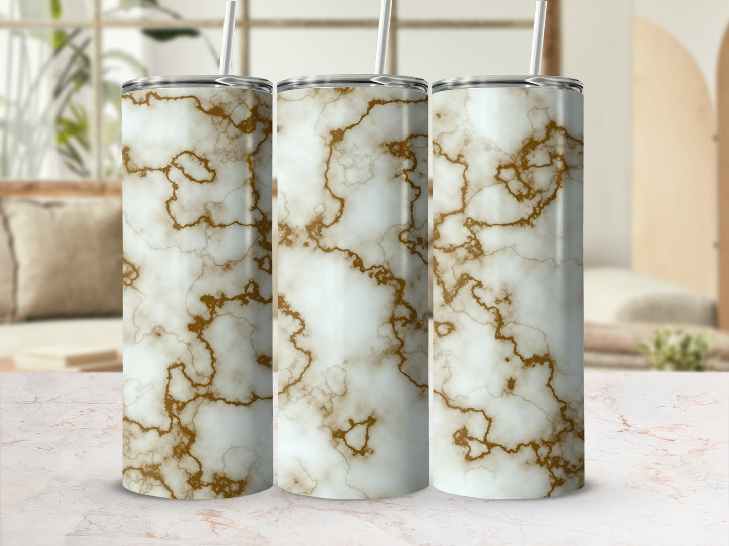 Three tumblers with a white and gold marble pattern and straws.