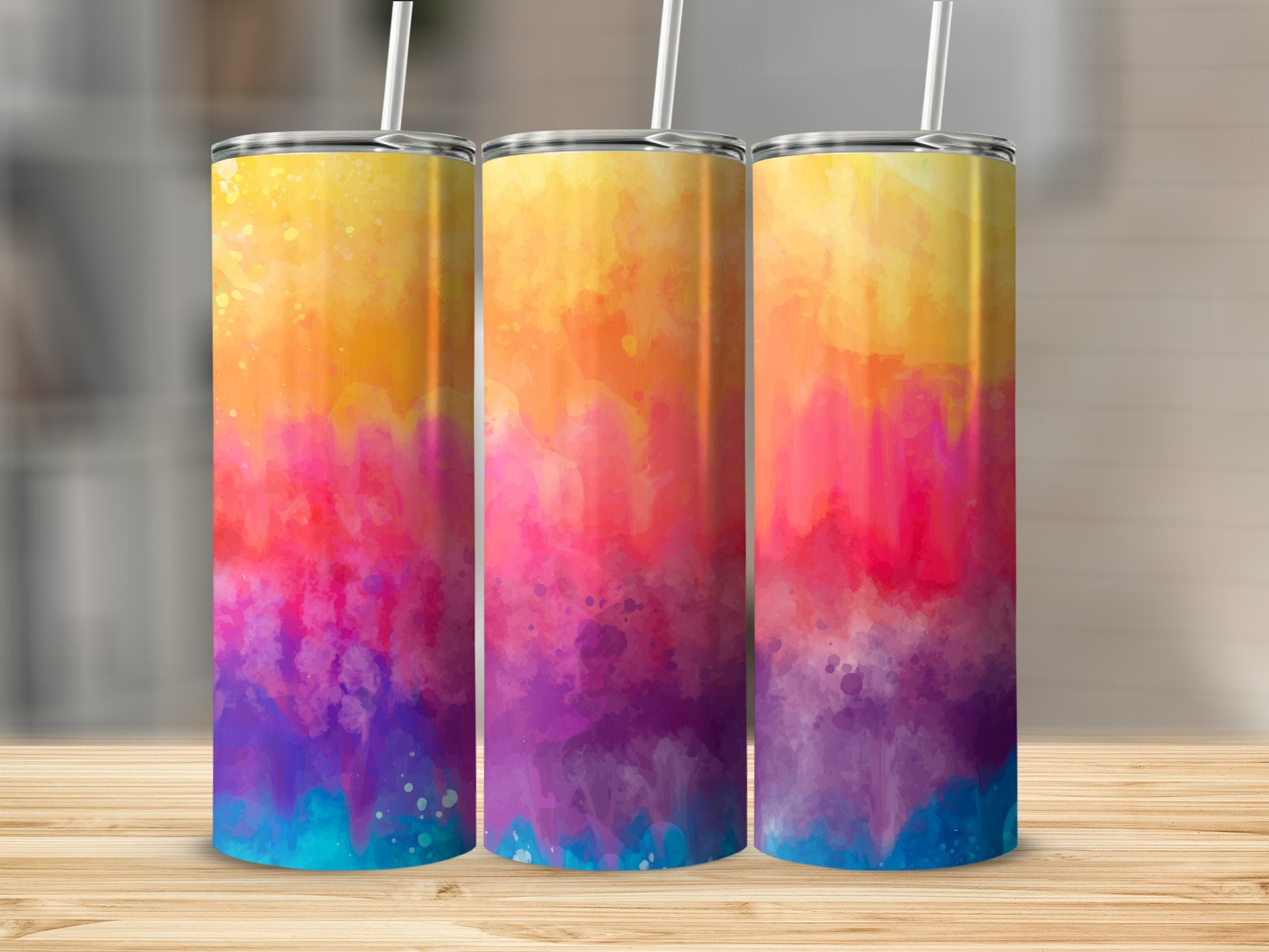 Three tumblers with a vibrant watercolor tie-dye design.