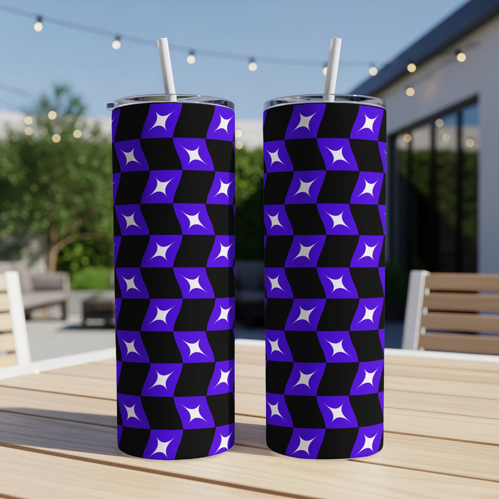 Two tumblers with purple and black geometric star pattern, on a table.