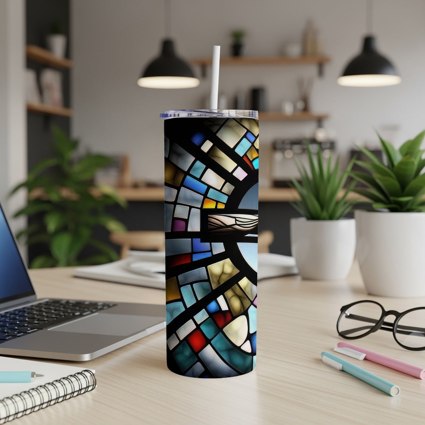 Stained glass pattern tumbler with straw on a desk.