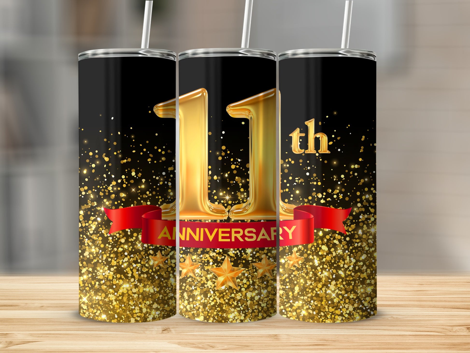 Gold 11th Anniversary tumbler with red ribbon and glittering stars on black.