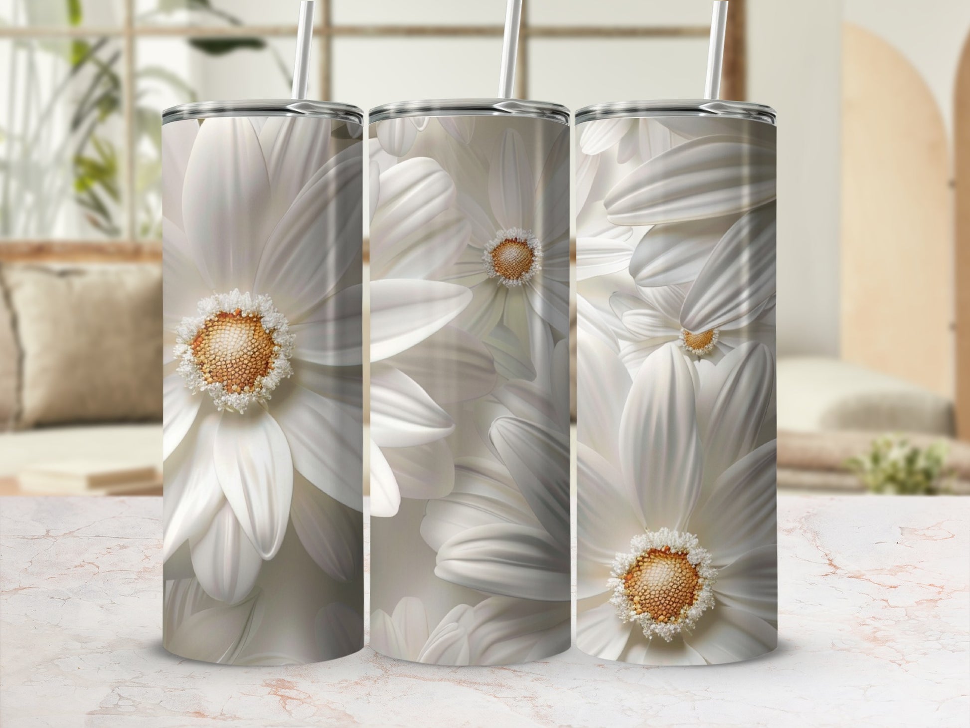 White daisy flowers wrap around three white tumblers with straws.
