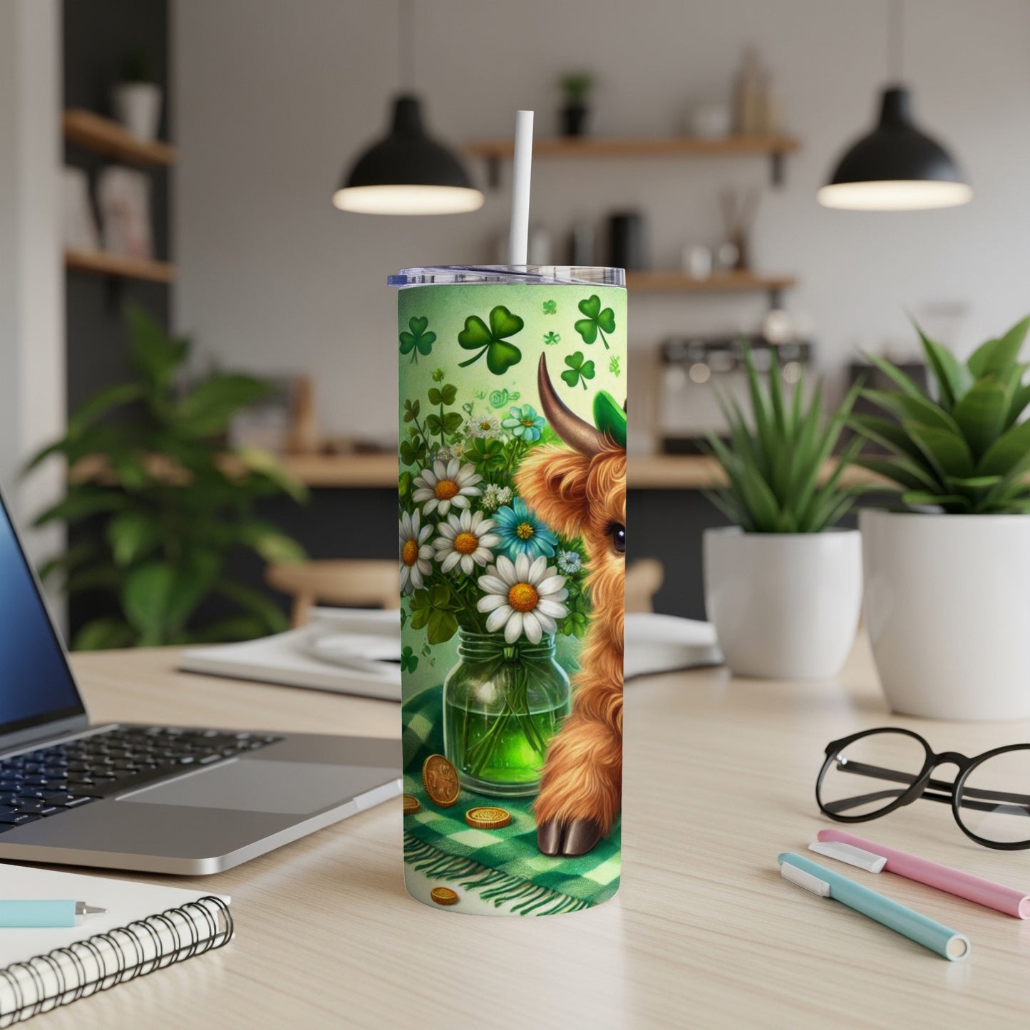 Highland cow with shamrocks and flowers on a St. Patrick's Day themed tumbler.