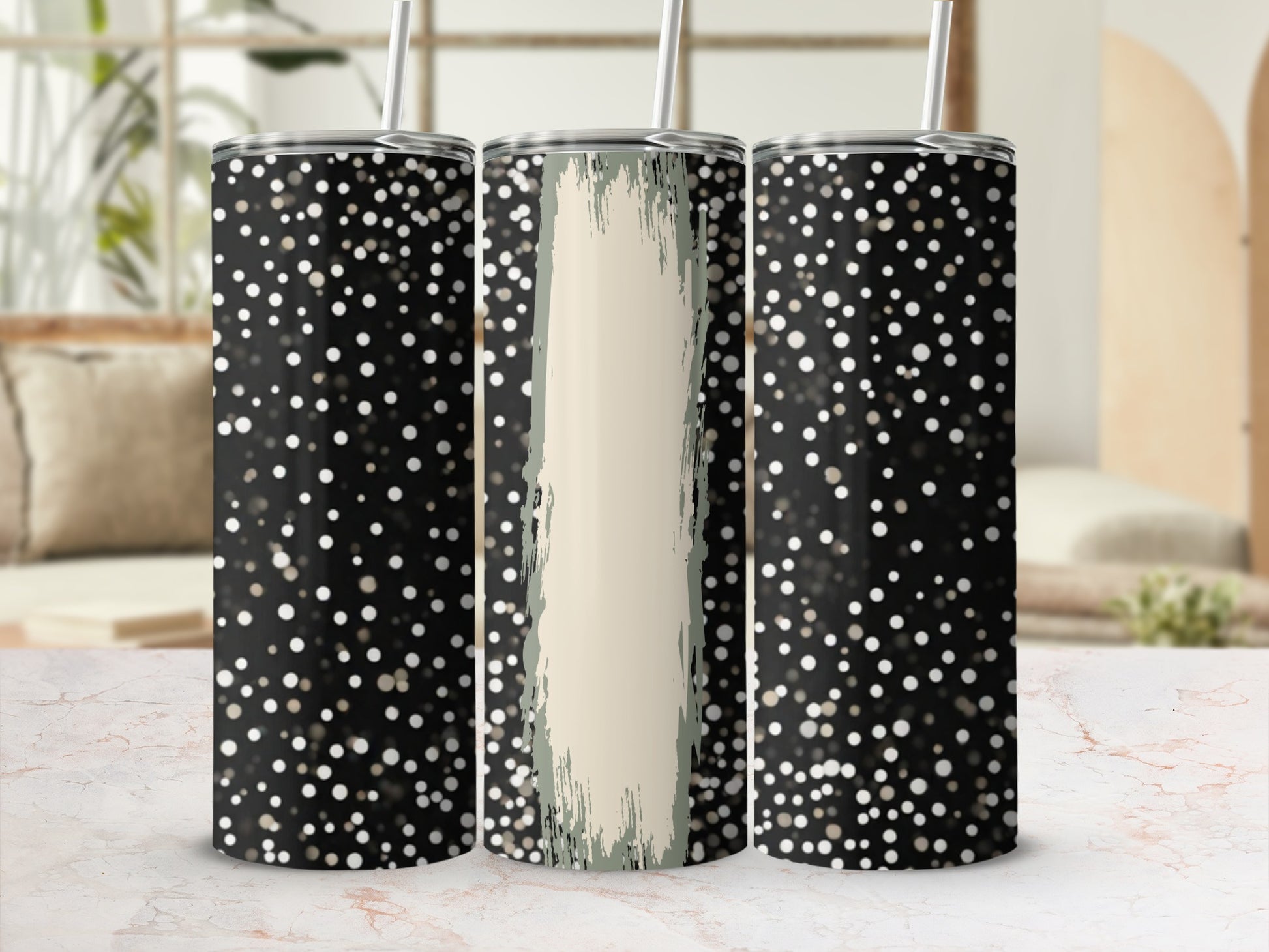 Three black tumblers with white polka dots and a textured tan stripe.
