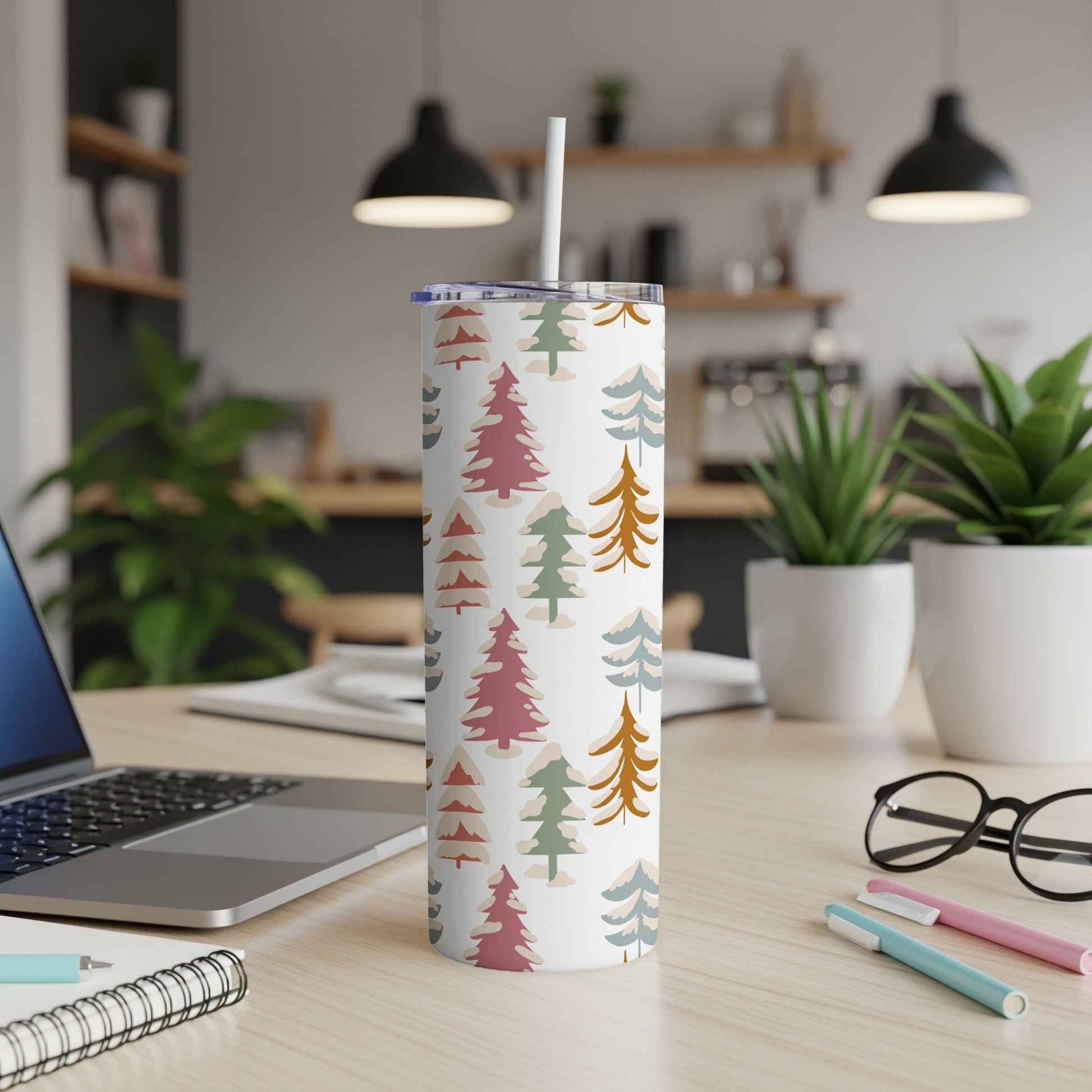 White tumbler with a pattern of colorful pine trees and dots.