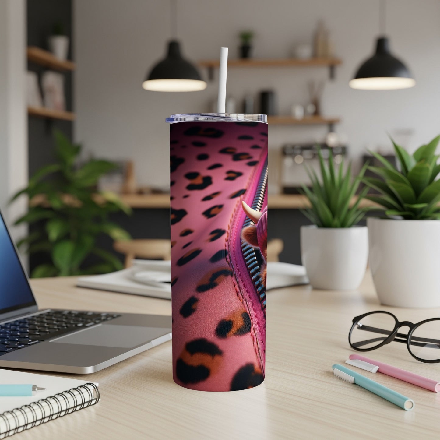 Pink leopard print tumbler with a cow face partially visible through an open zipper.