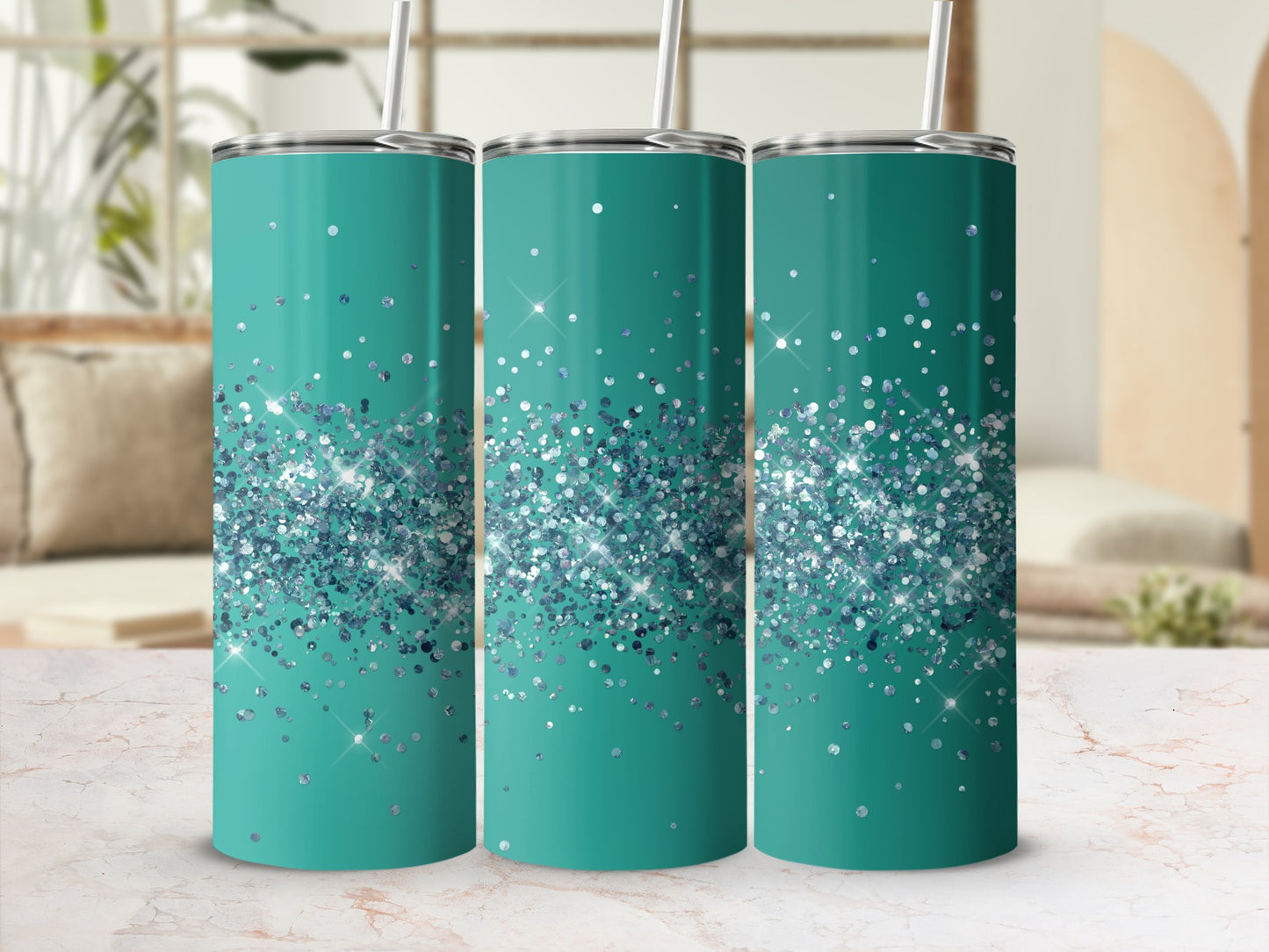 Three teal tumblers with scattered blue and silver glitter design and straws.