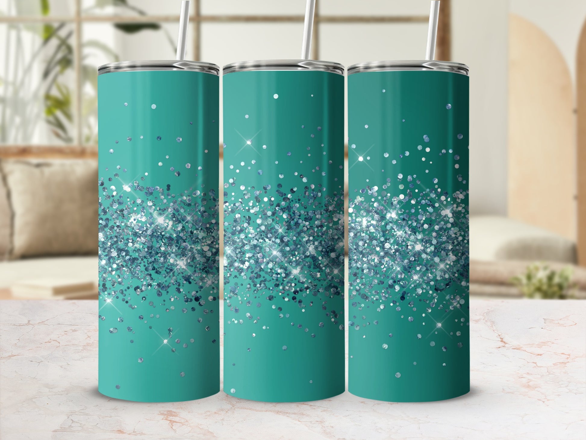 Three teal tumblers with scattered blue and silver glitter design and straws.