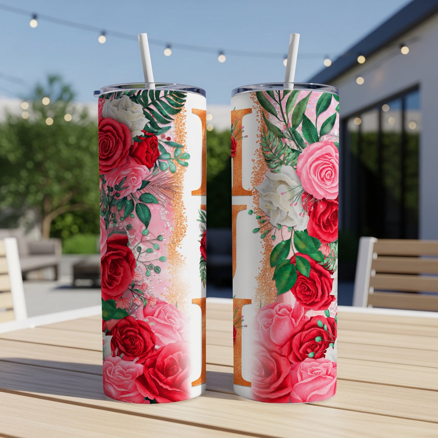 Two tumblers with floral designs and pink, gold, and white accents.