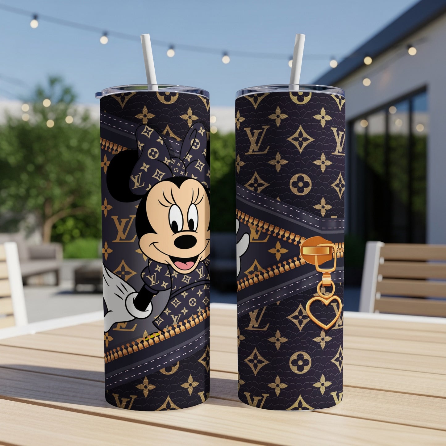 Minnie Mouse design on a dark tumbler with a gold zipper and heart charm.