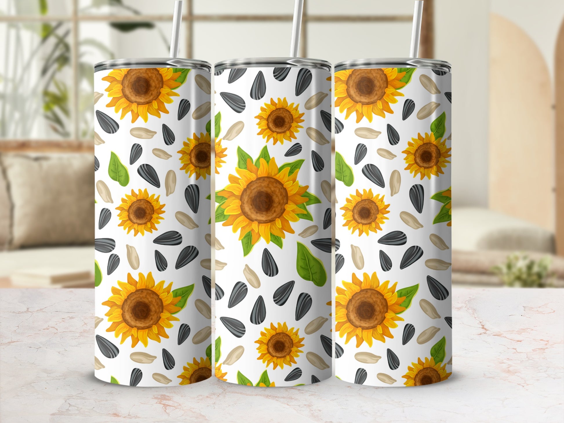 Three tumblers with a repeating pattern of sunflowers and sunflower seeds.