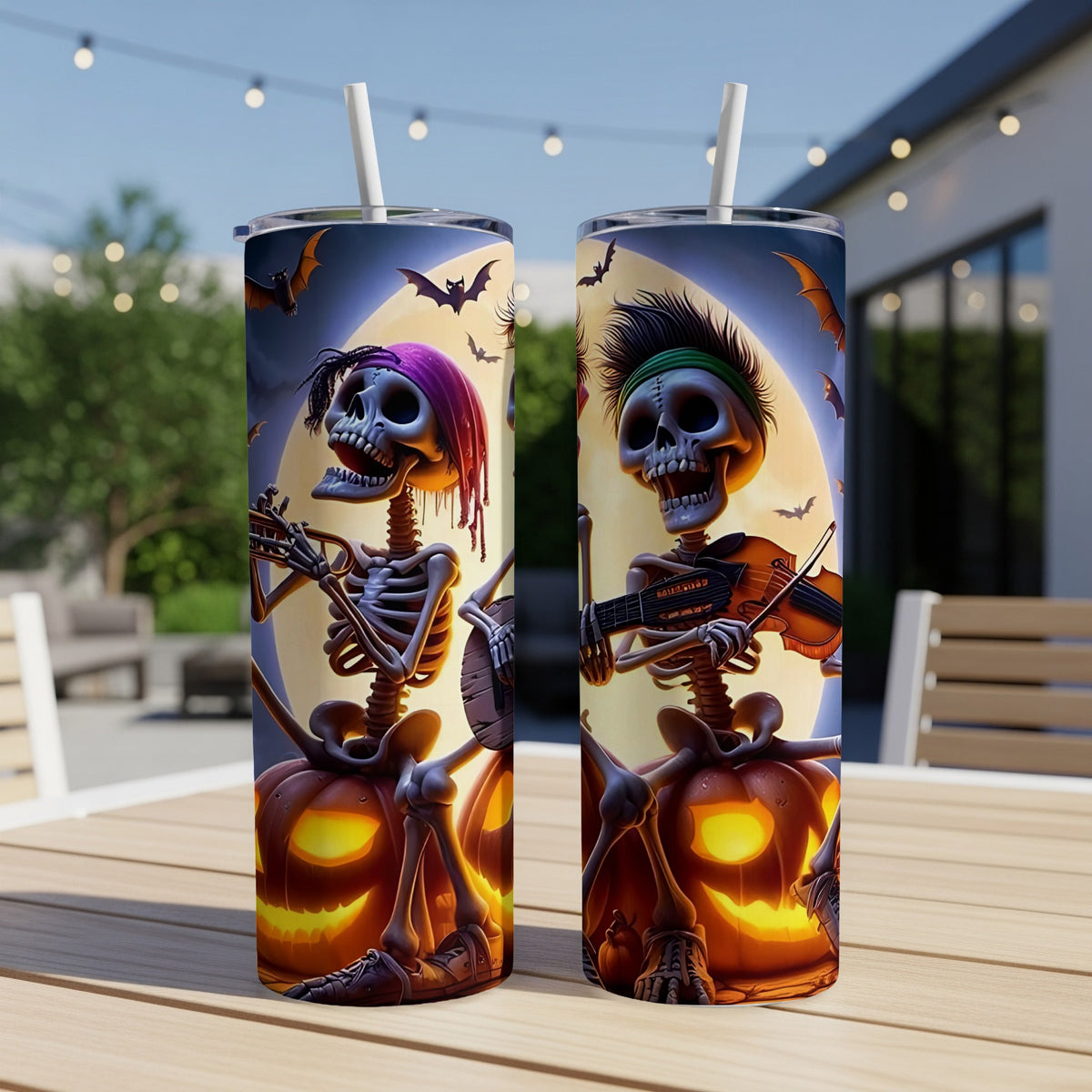Two tumblers featuring skeletons playing instruments in front of a full moon and pumpkins.