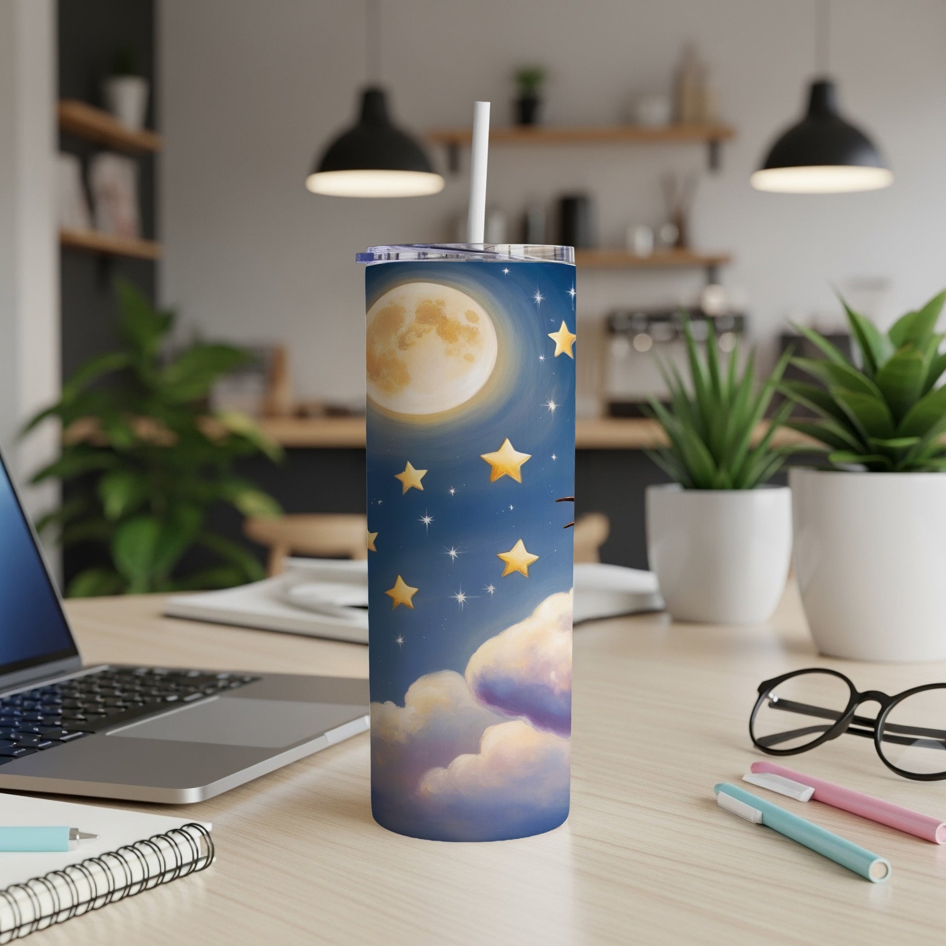 Celestial design with moon, stars, and clouds on a tumbler with straw.