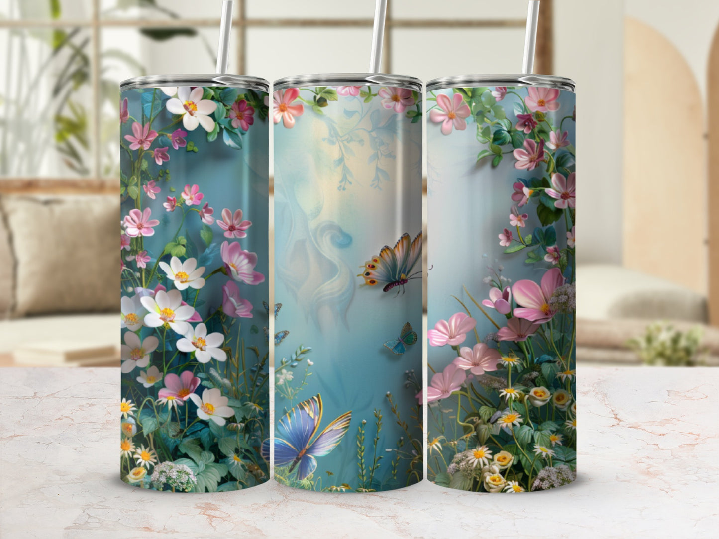 Floral pattern with butterflies on a blue background, on three tumblers.